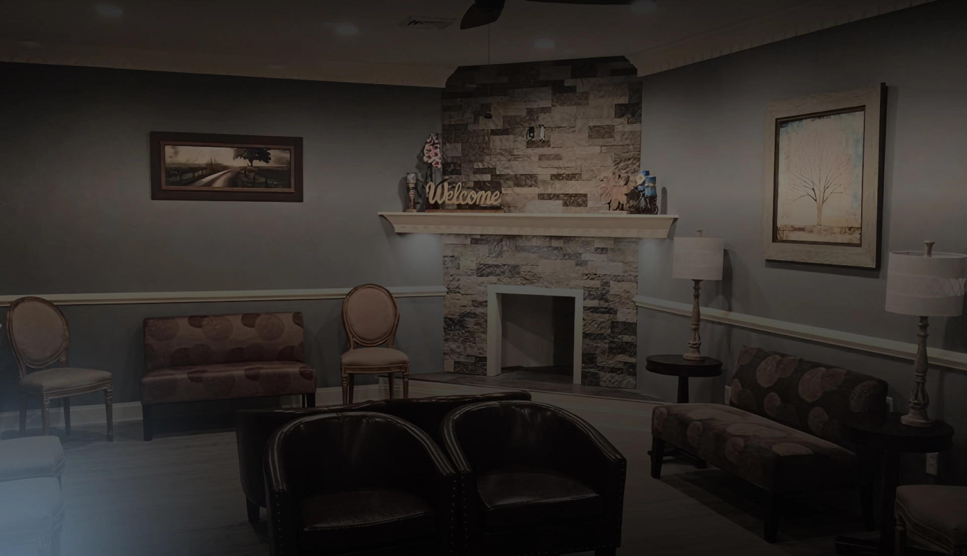Waiting room with fireplace, seating area, and modern dental office décor in warm tones.
