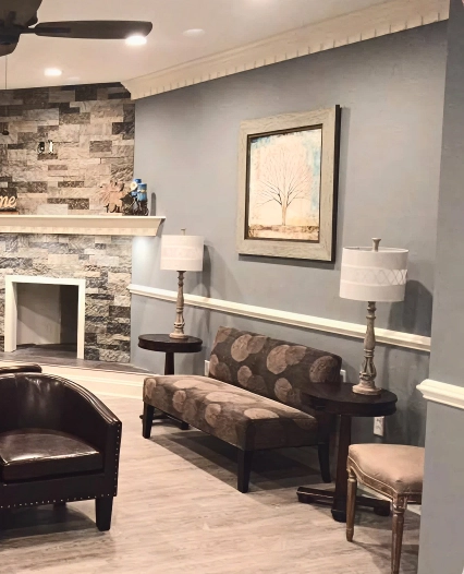 Modern dental office waiting room with leather seating, fireplace, and contemporary decor.